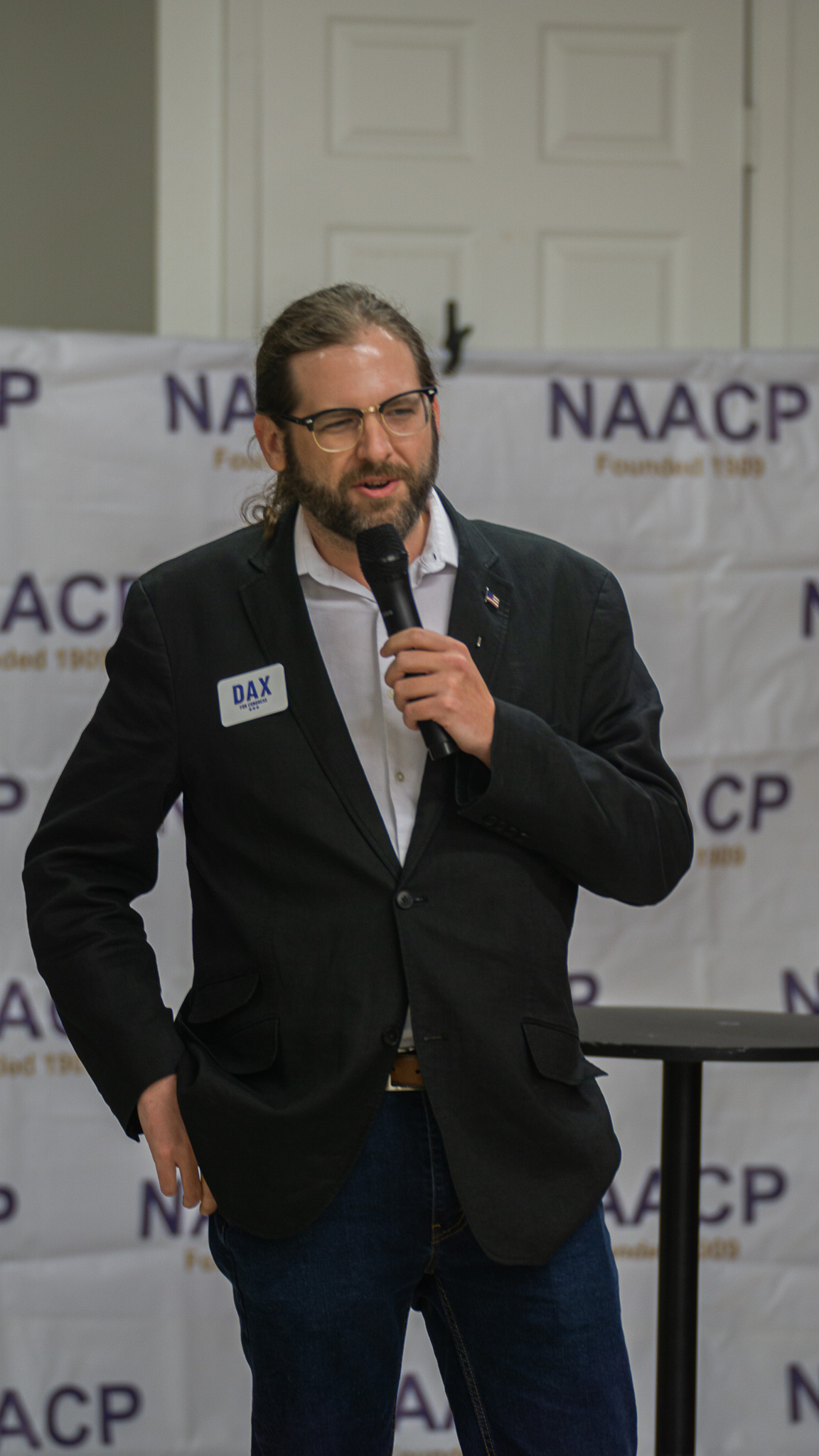 Candidate speaking with microphone at NAACP campaign event
