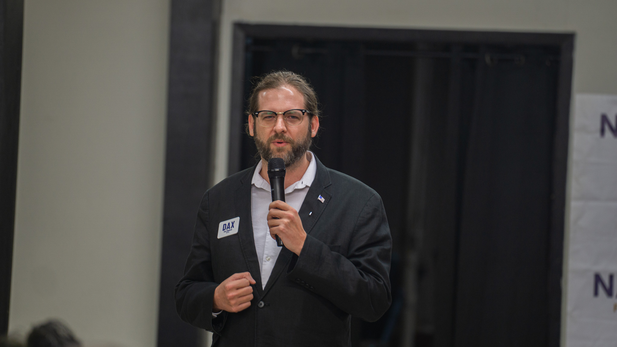 Candidate speaking with microphone at a community event