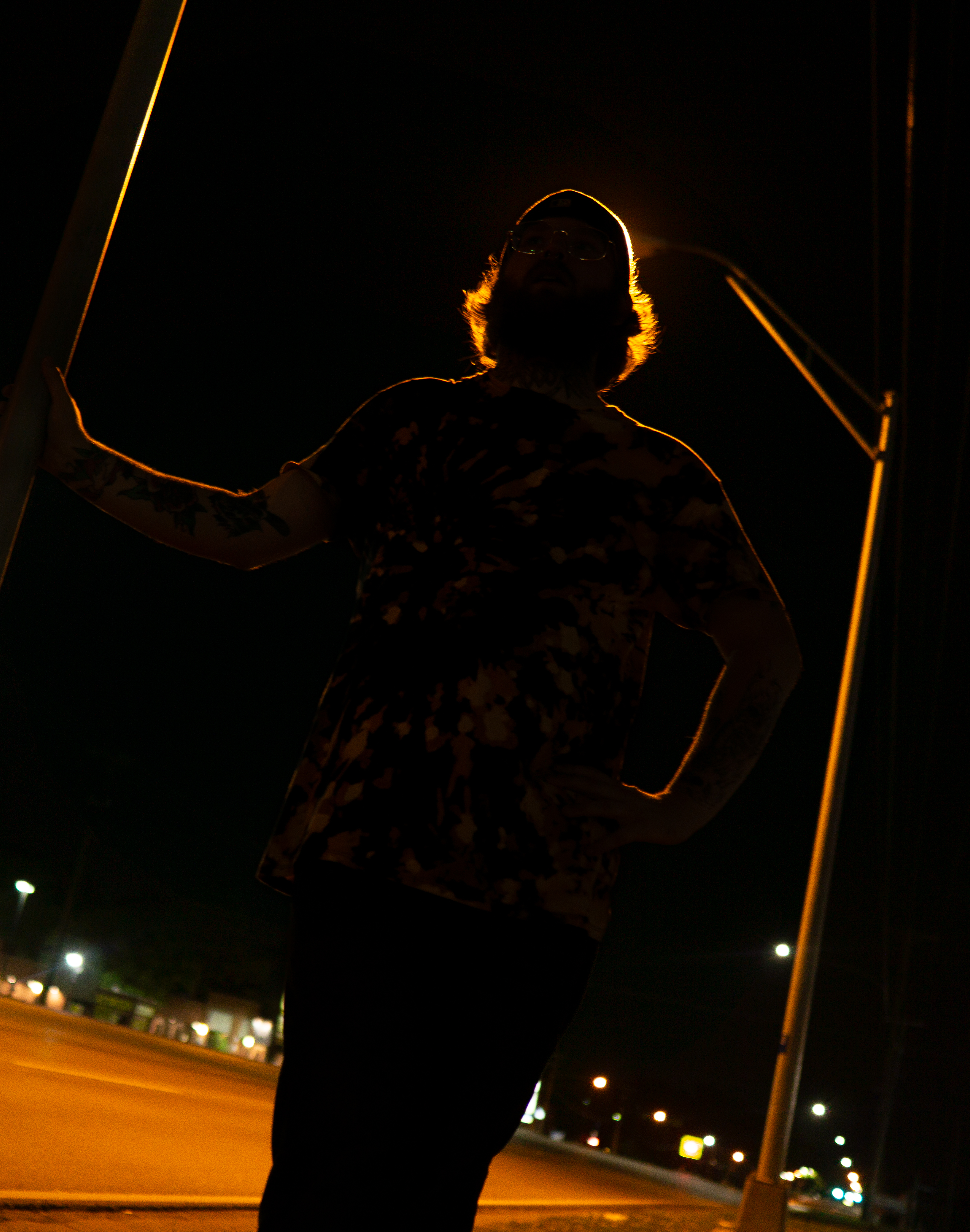 Artistic edit: backlit silhouette portrait under a streetlight at night