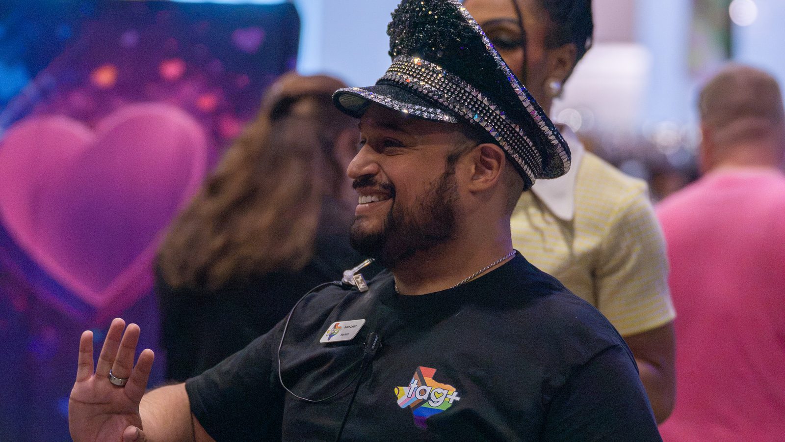 Attendee smiling with pink balloons in the crowd