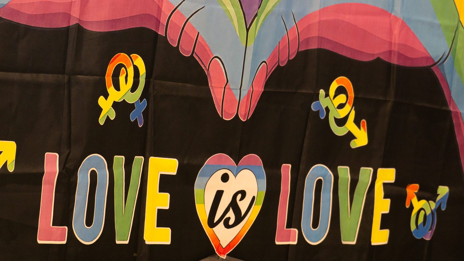 Love is Love banner hanging above the festival crowd