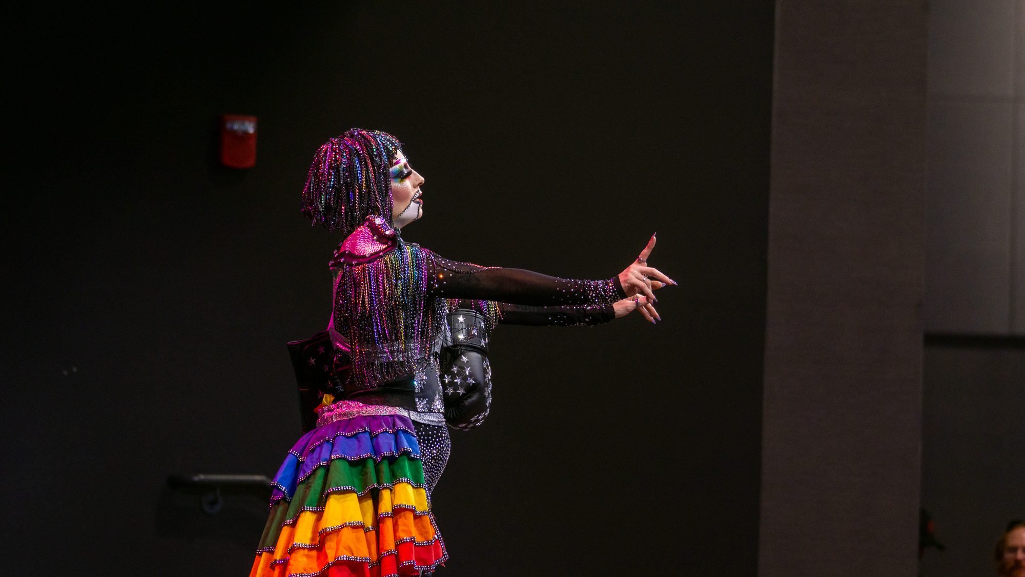 Drag performer in rainbow colors greeting the Pride 2026 crowd