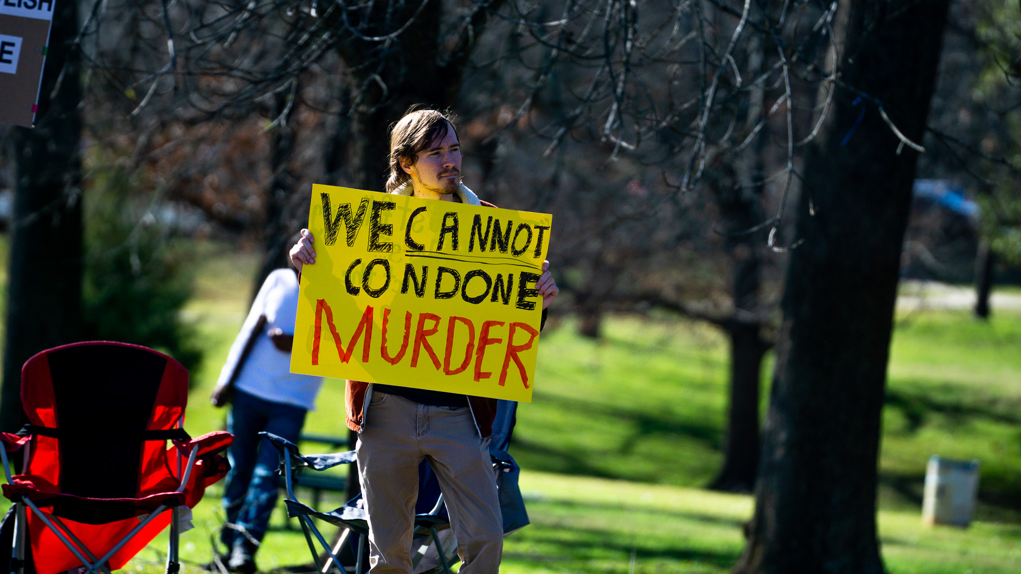 Group of protesters with handmade signs along the street