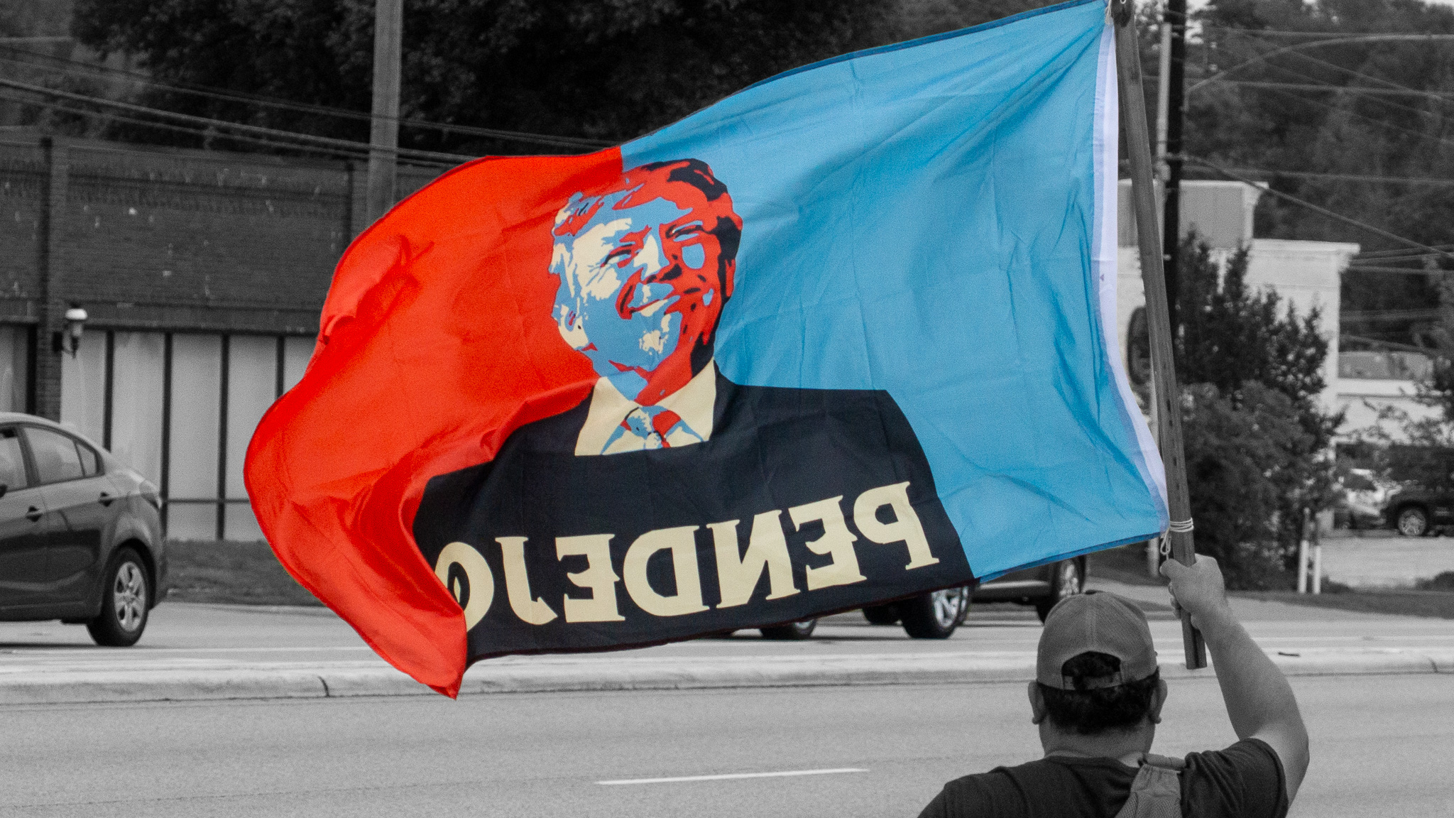 American flag and protest flag at outdoor demonstration