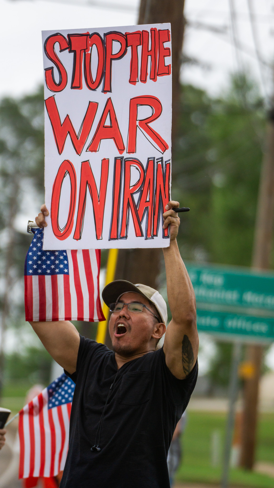 Protester with Healthcare Not Warfare sign